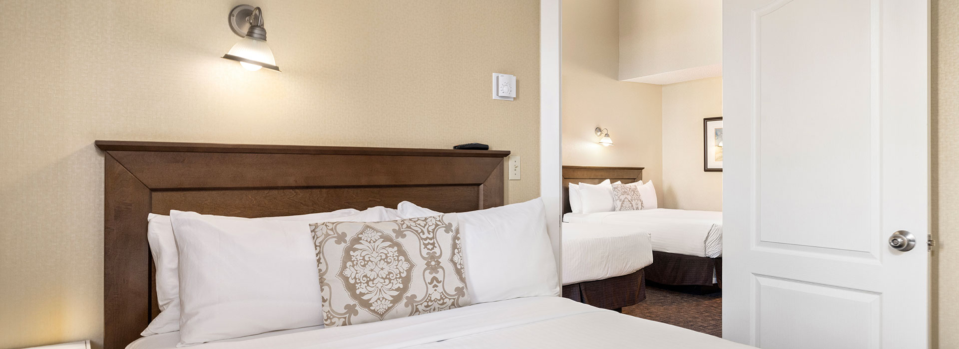 SUperior two bedroom hotel room with 3 queen beds